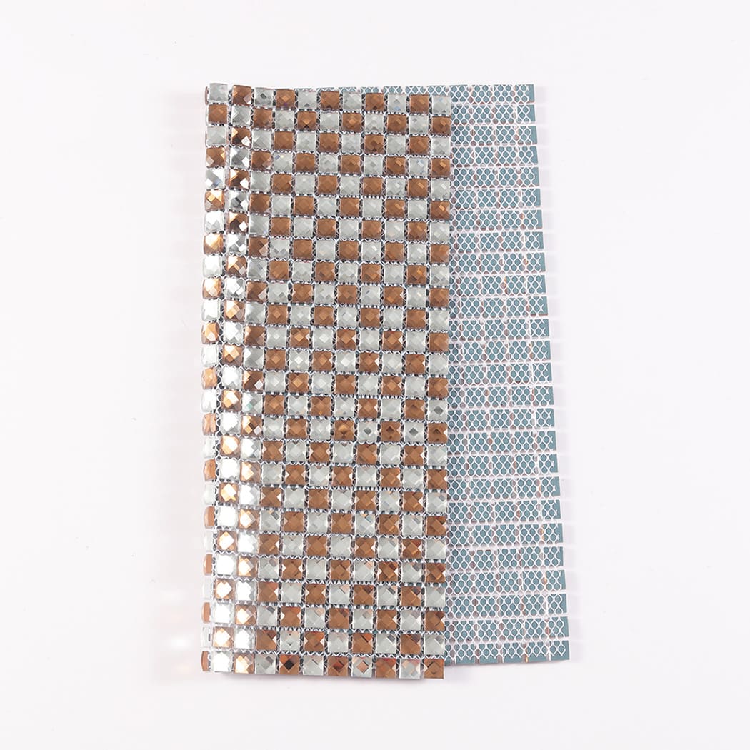 Folded rose gold and silver diamond glass mosaic sheet showing its flexible mesh backing.