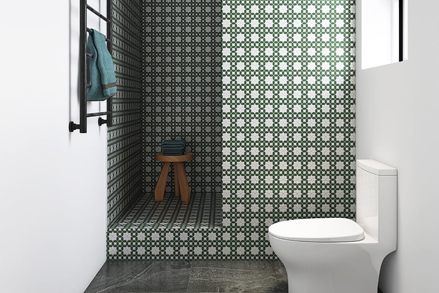 Bathroom with geometric tile pattern in dark and light green contrast tiles