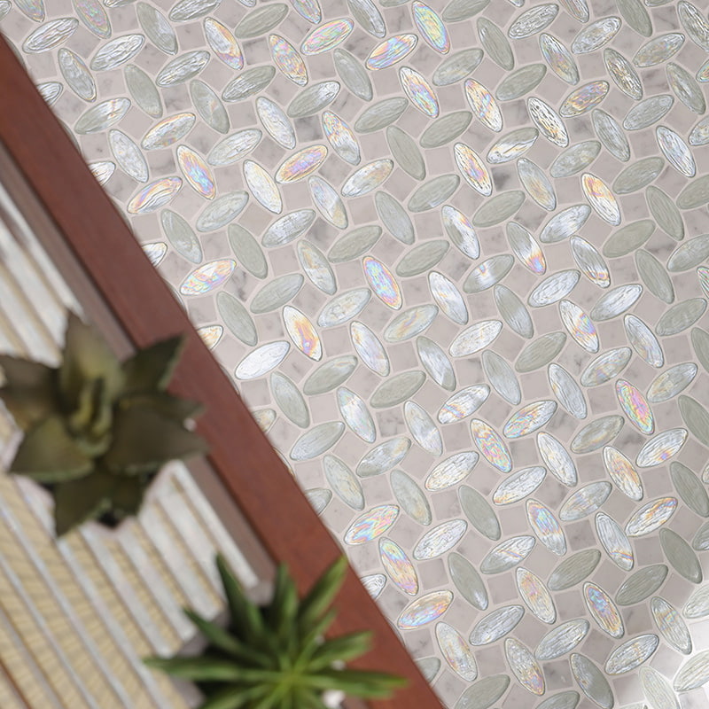 Close-up of iridescent glass and marble mosaic tiles in leaf pattern