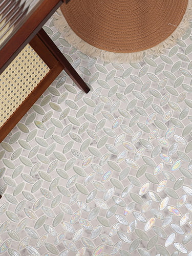 Glass and marble mosaic tile floor with round woven carpet