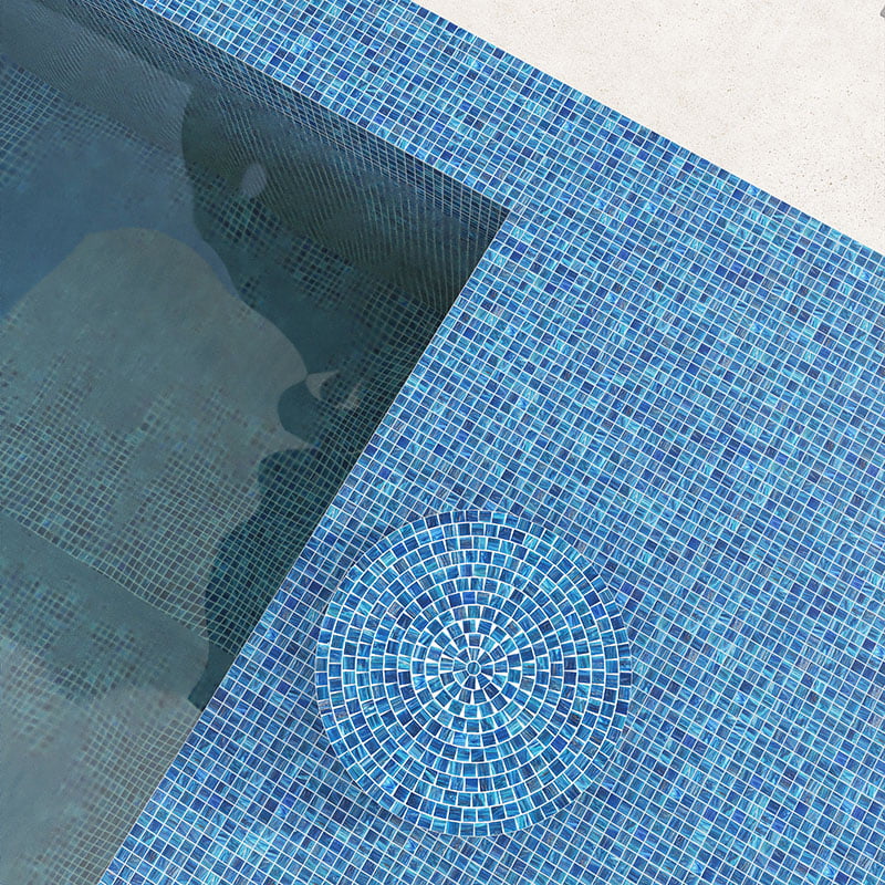 Glass pool tiles in blue mosaic design at swimming pool corner