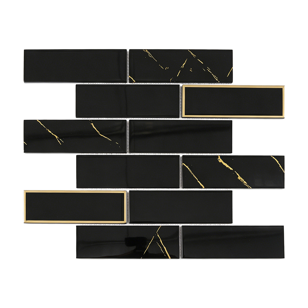 Glossy black glass subway tile in staggered pattern with gold accents