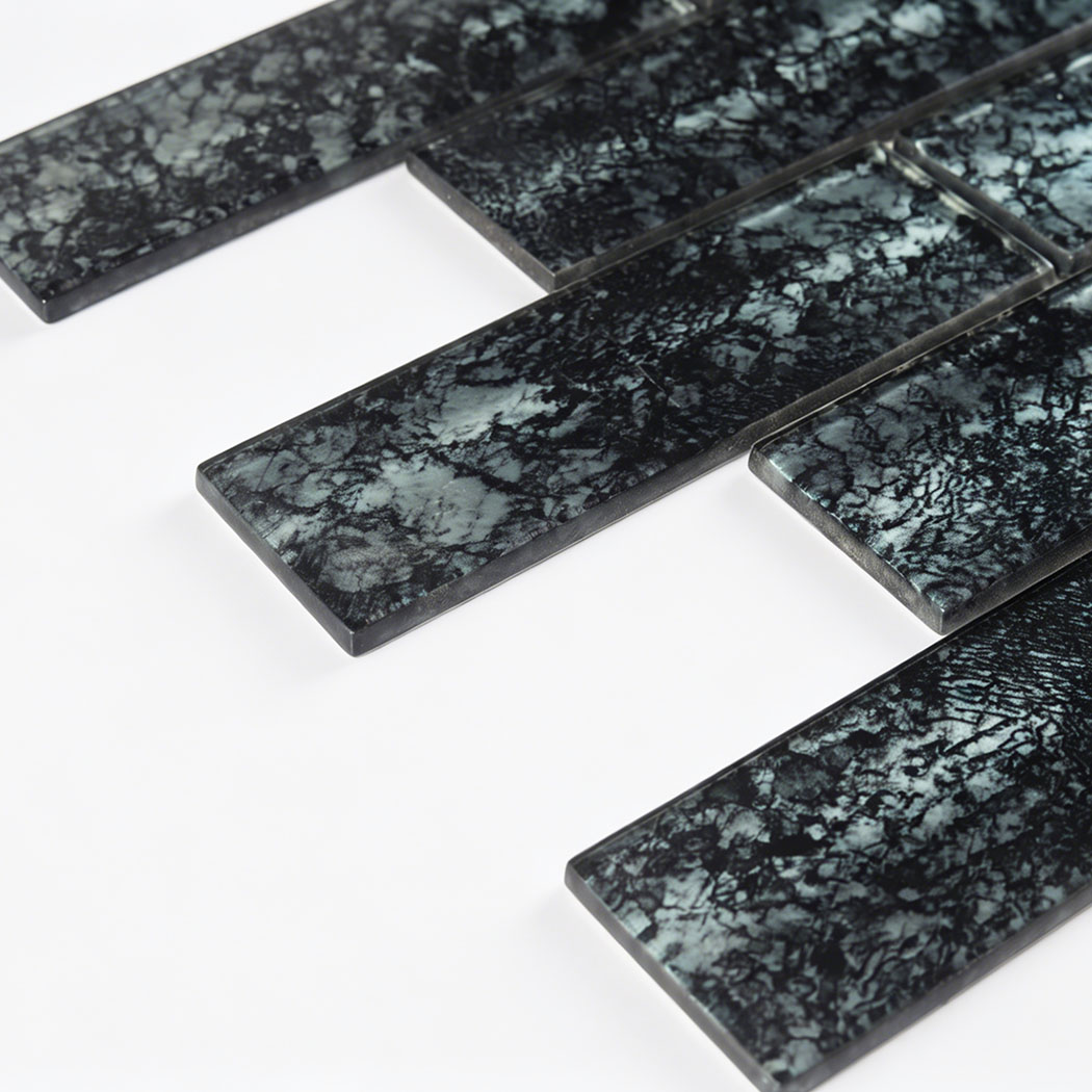 Glossy black gray crackle glass subway tile close up with raised edges