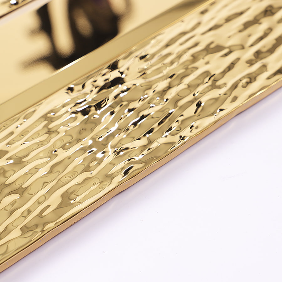 Angled view of glossy gold stainless steel vertical subway mosaic tile sheet