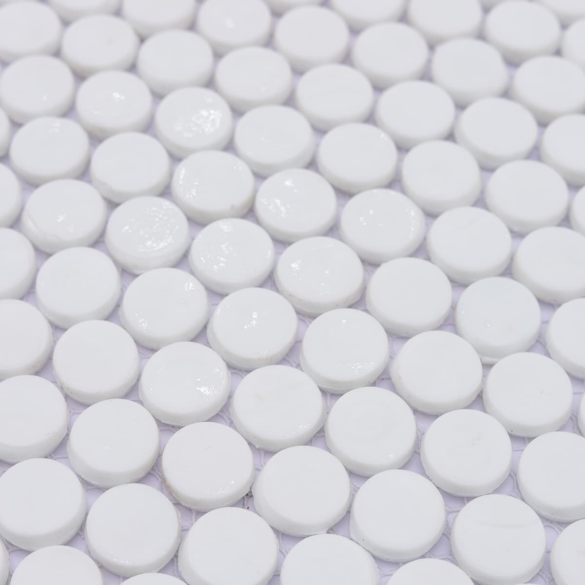 Detail of glossy round white mosaic tiles arranged neatly in rows