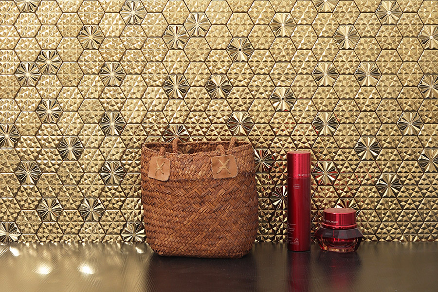 Gold 3D hexagon metallic kitchen tiles with faceted geometric texture.