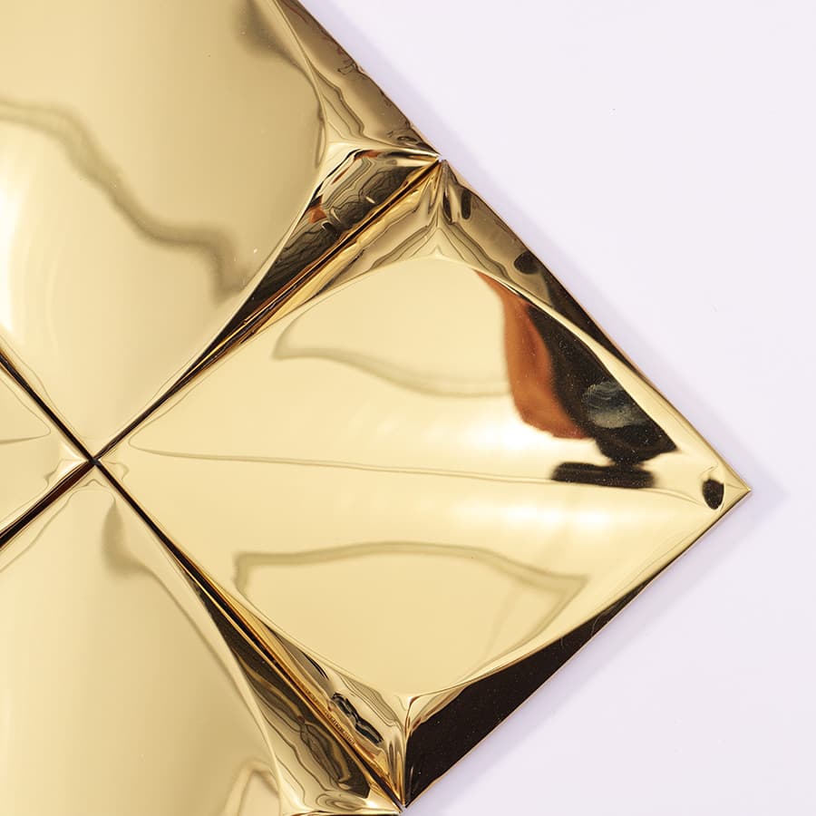 Top corner view of gold 3D square tile
