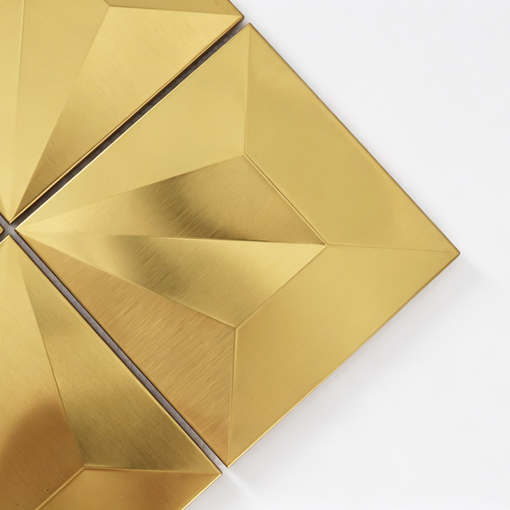 Close up of gold brushed pyramid square metal tile with raised facets