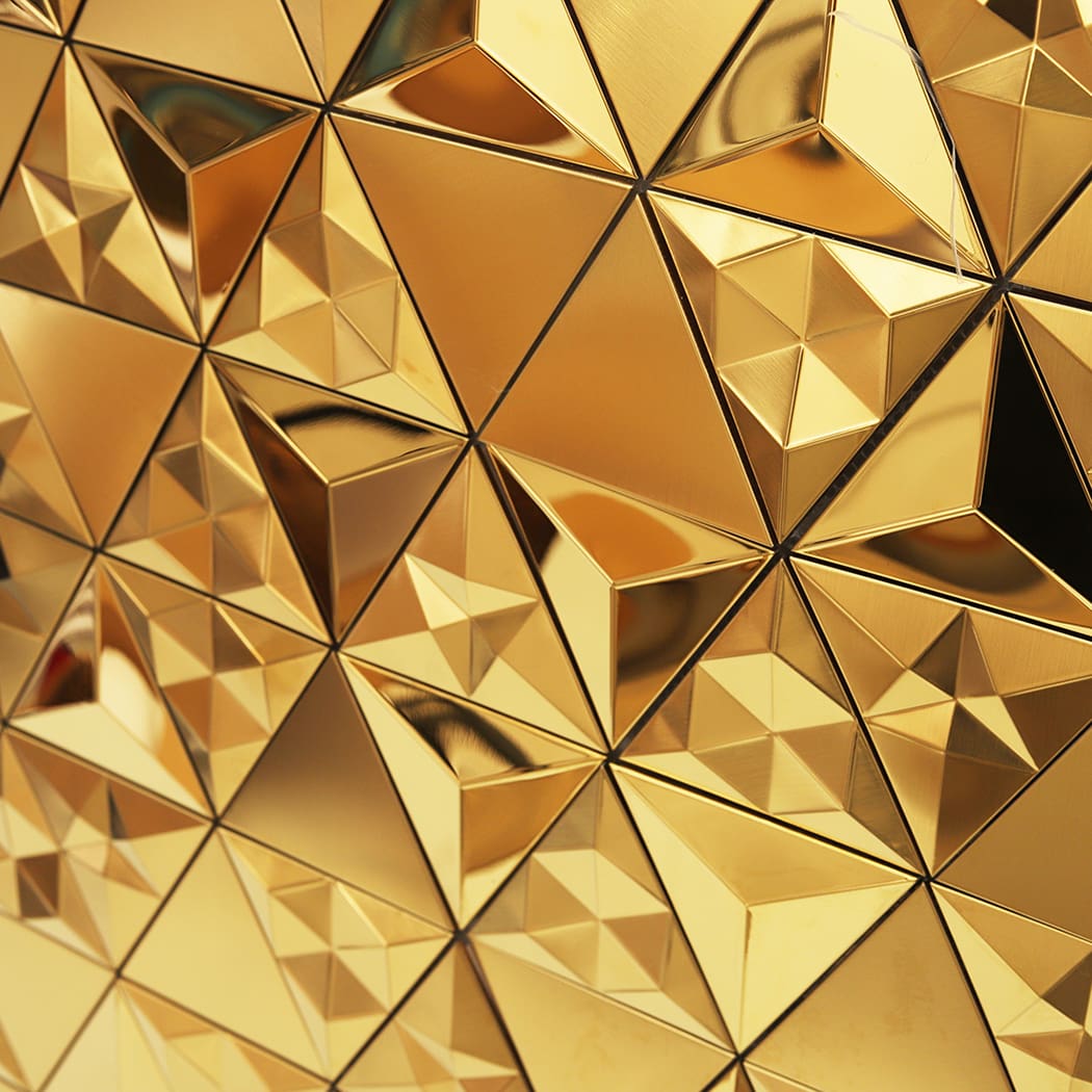 close-up view of 3D gold triangular mosaic tiles with reflective surfaces.