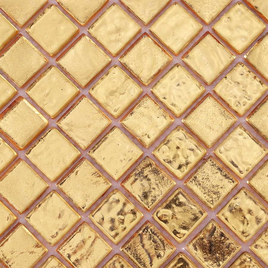 Close-up of gold glass mosaic tile surface with reflective finish.