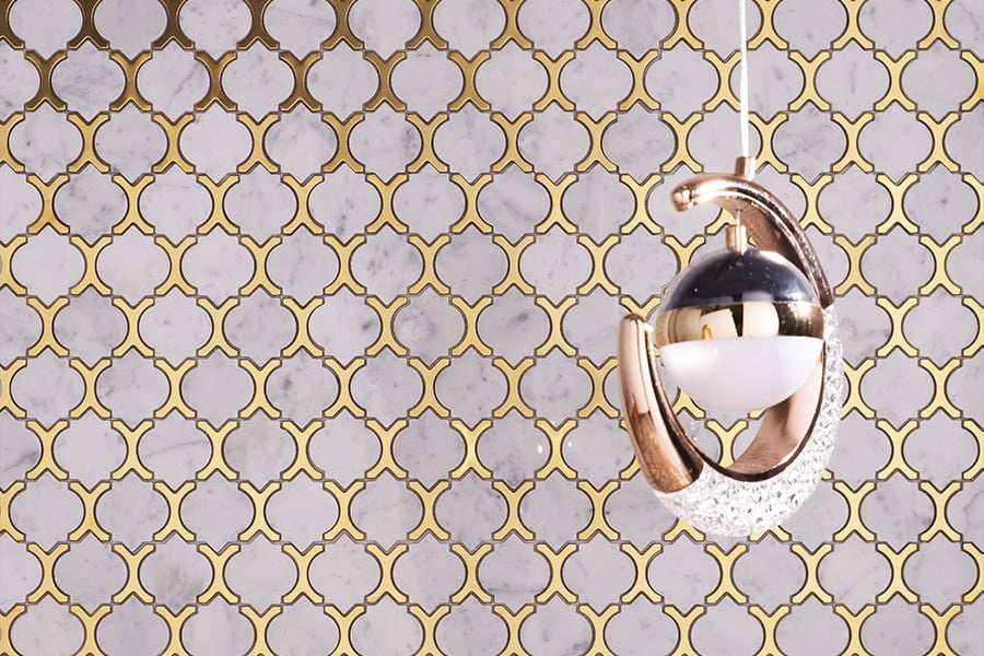 Glossy gold and marble arabesque mosaic tiles as decorative wall background