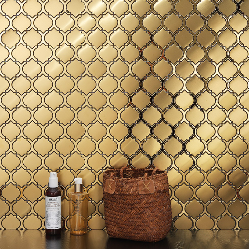 Gold metallic Arabesque wall tiles creating a luxurious bathroom backsplash focal point.