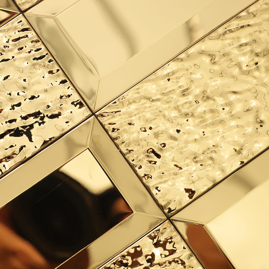 Detailed view of gold mirror tile surface with wavy texture.