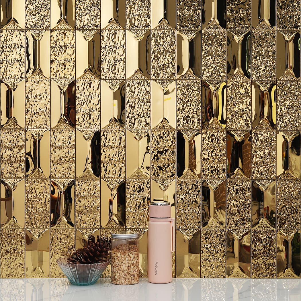 Gold mosaic tile backsplash in a kitchen setting with a thermos and jar.