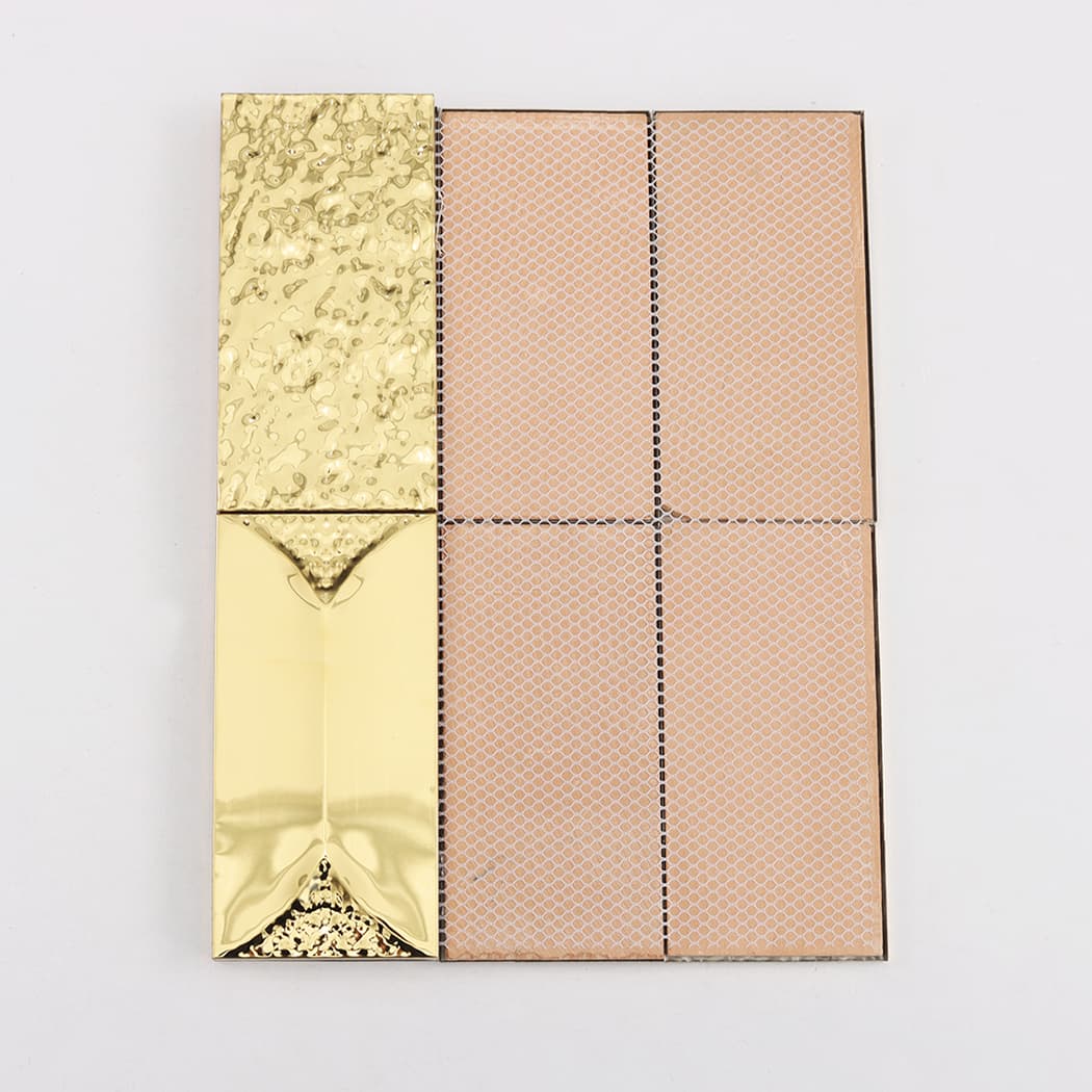 The back of a gold mosaic tile sheet showing the fiber mesh support.