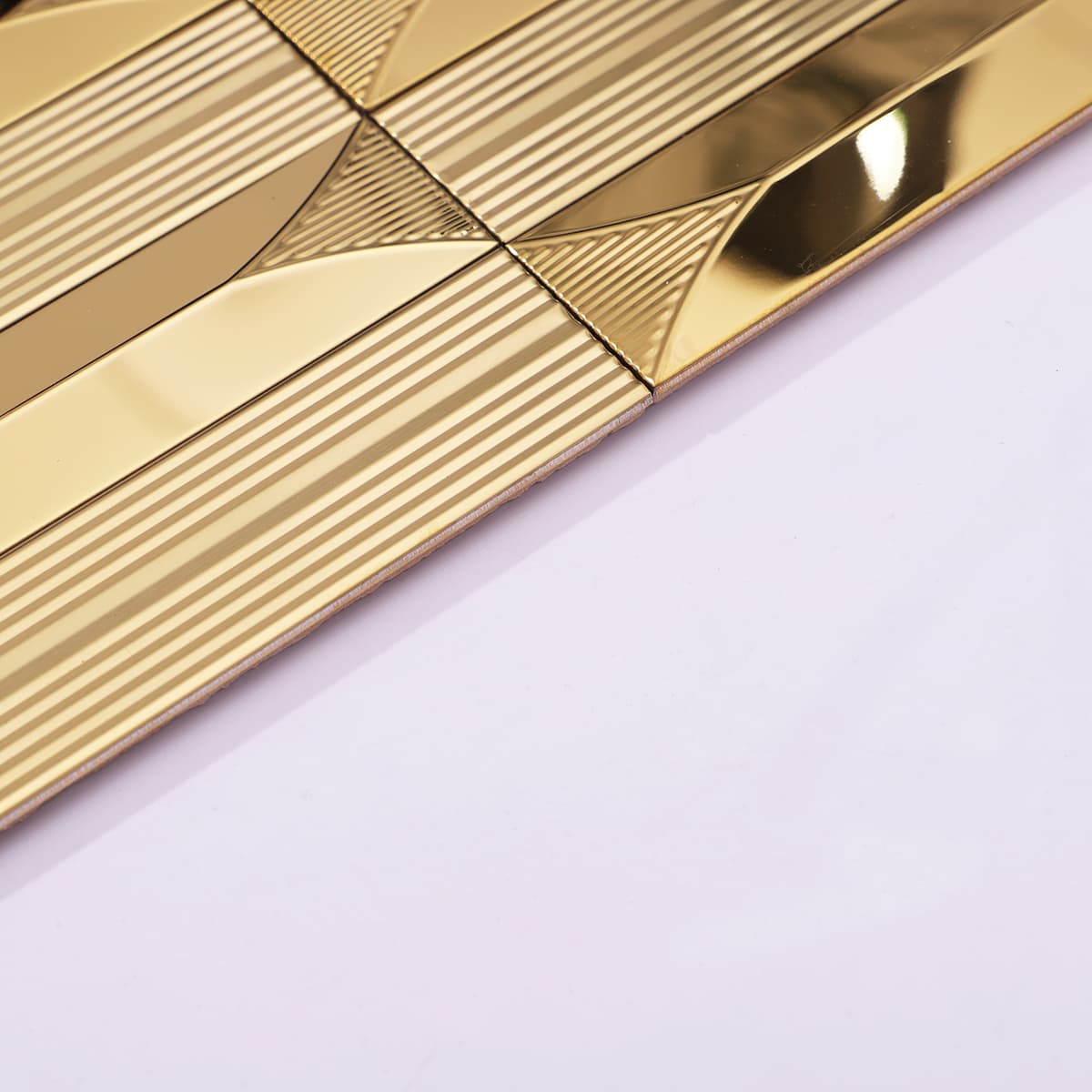 Side angle showing the beveled edge and layered build of gold stainless mosaic