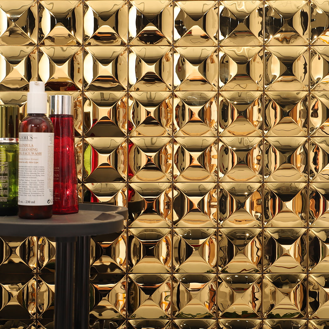 3D gold stainless steel square wall tile used as bathroom wall decoration.