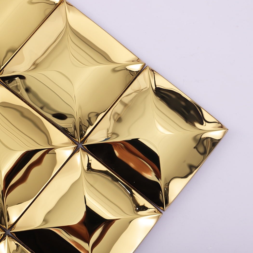 Close-up of the corner edge of 3D gold stainless steel square wall tiles.