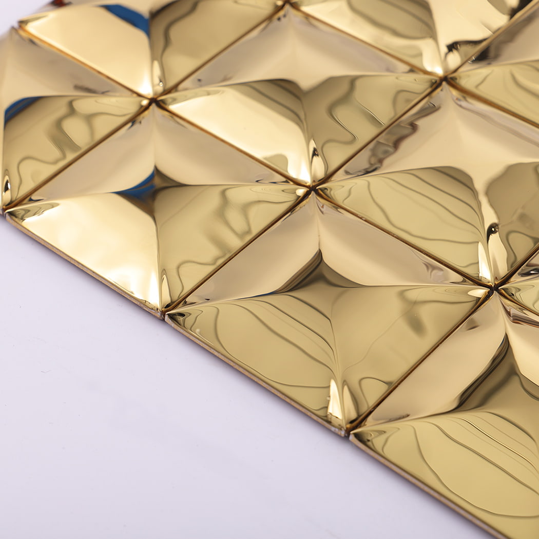 Side angle view of gold stainless steel 3D wall tile showing depth and reflection.
