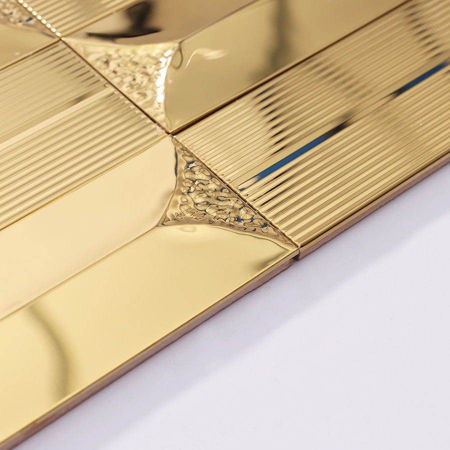 Side angle view of gold stainless steel wall tile showing 3D design and surface shine.