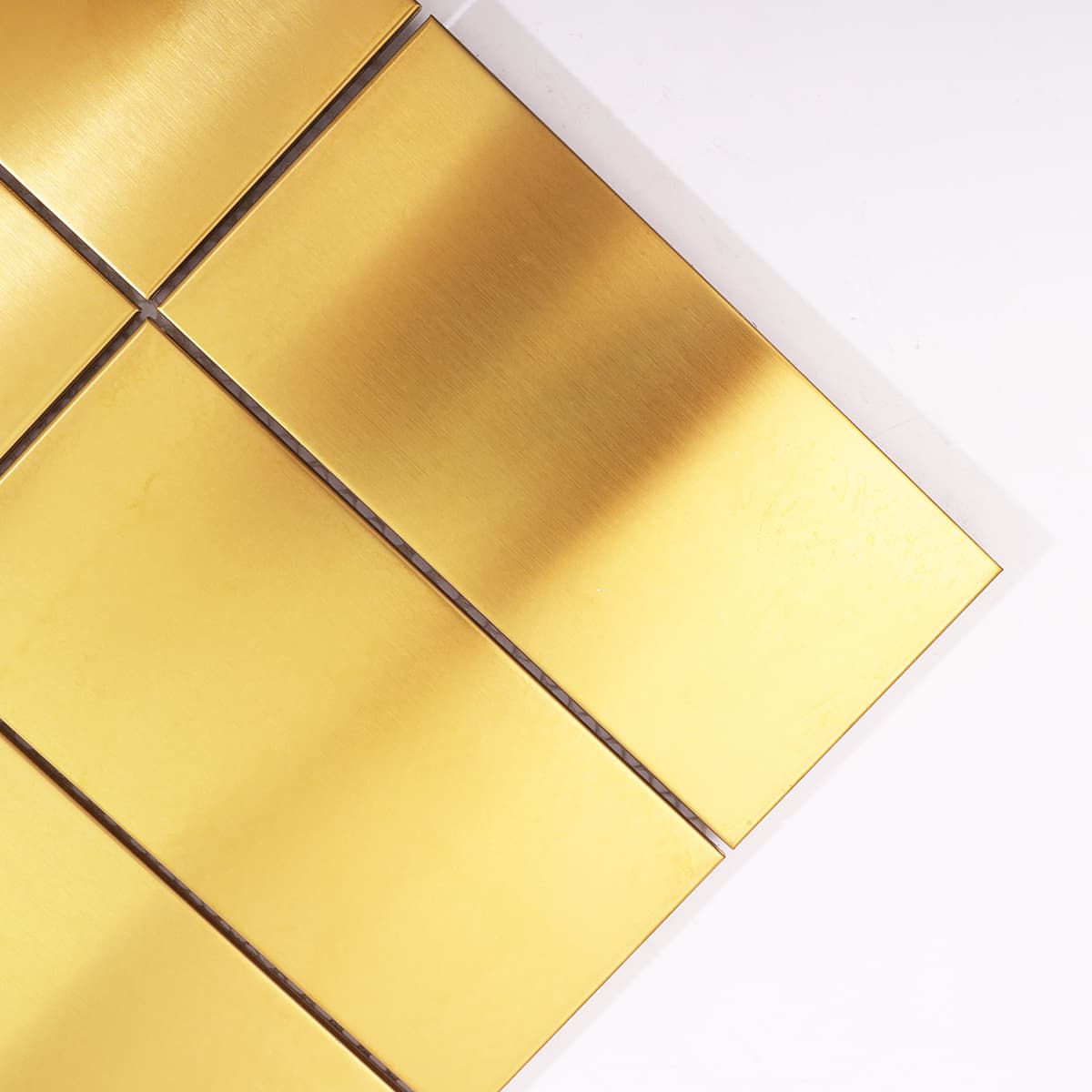 Close-up of brushed gold stainless steel tile edge