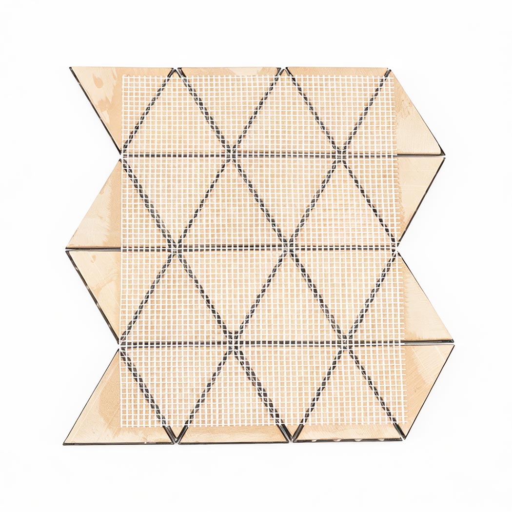 Back view of gold triangle metal mosaic tile sheet with mesh mounting