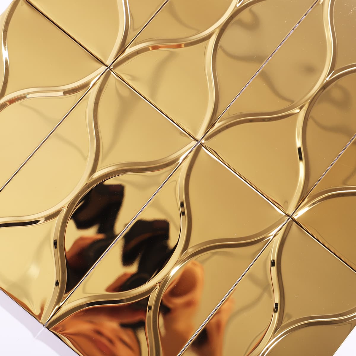 Close-up of glossy gold wave pattern metal mosaic tile