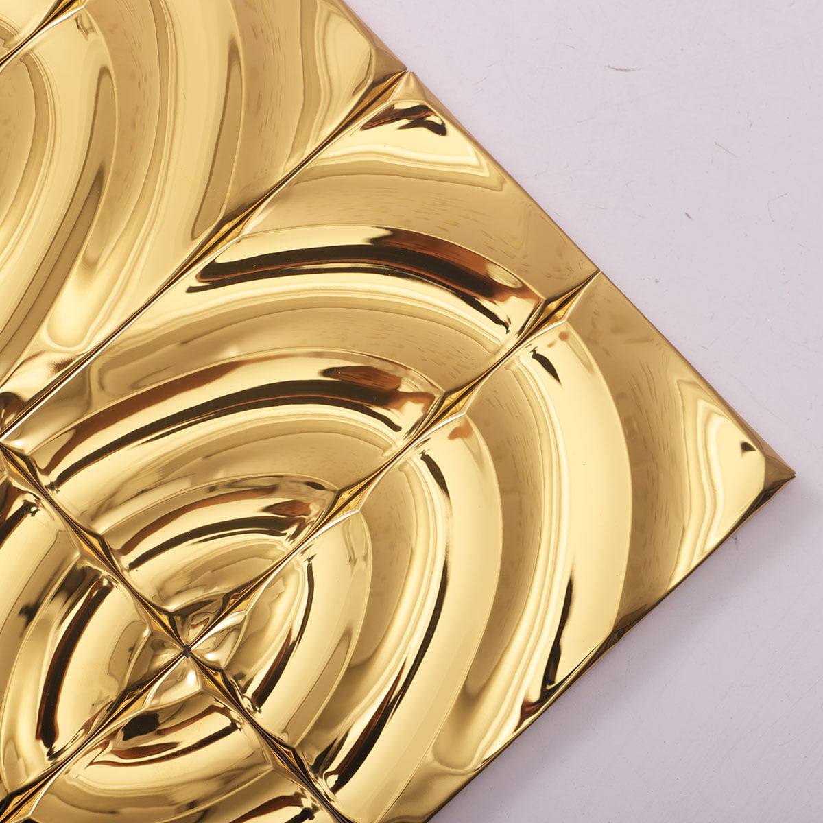  Close-up of a pattern made from shiny gold wavy tiles