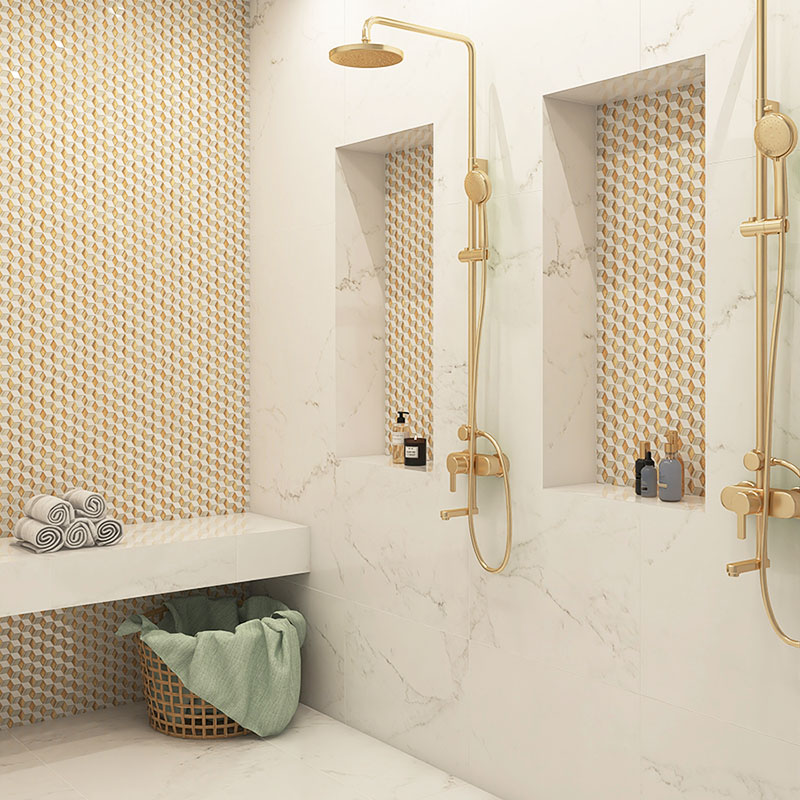 Gold and white geometric mosaic shower wall with recessed niches and brass shower fixtures