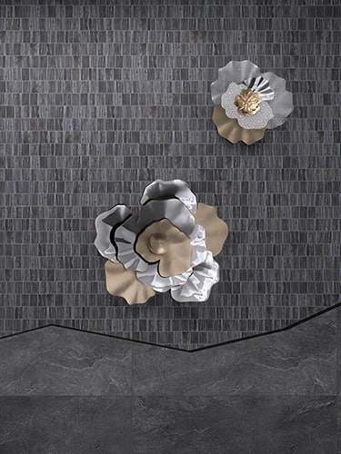 Dark gray marble mosaic wall with flower sculpture accent