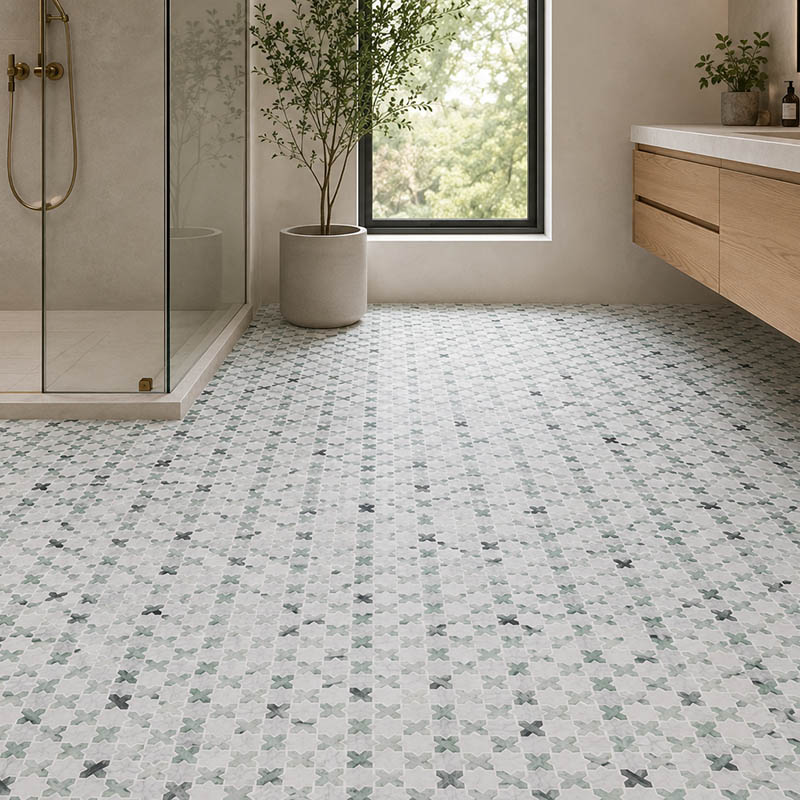 Gray and green modern geometric floor tiles in a bright bathroom with wood vanity