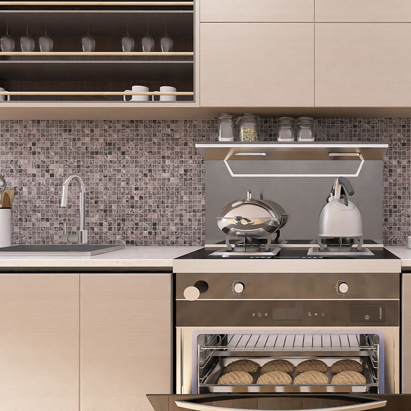 Close-up of gray mosaic backsplash tile behind stovetop and sink