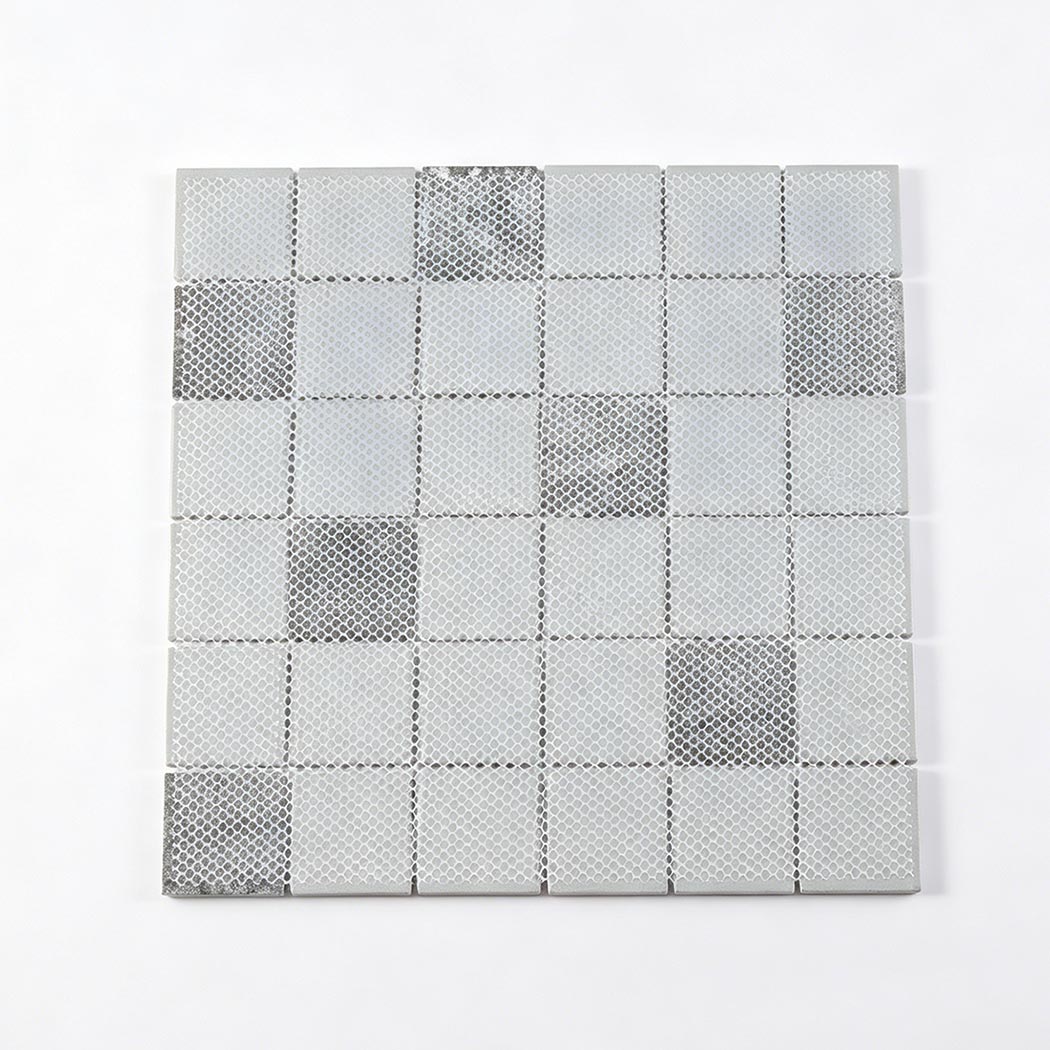 Back view of gray square glass mosaic sheet with mesh mounted backing for installation