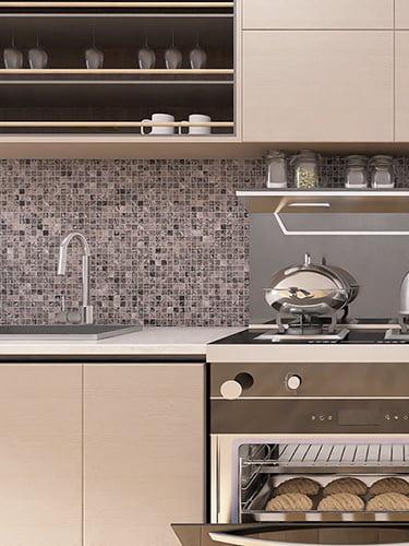 Gray mosaic tile backsplash with natural stone texture in modern kitchen