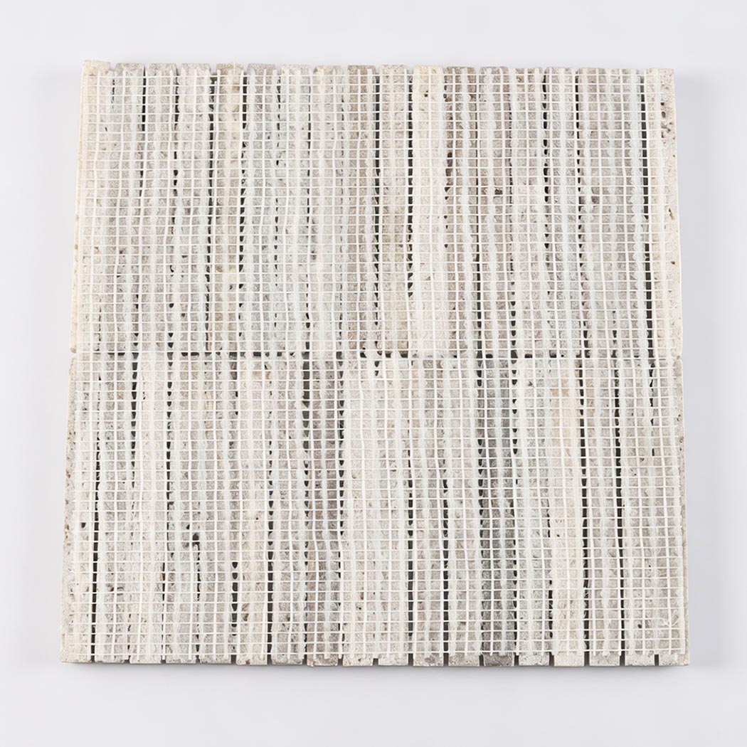 Gray travertine fluted mosaic tile showing vertical strips and mesh backing