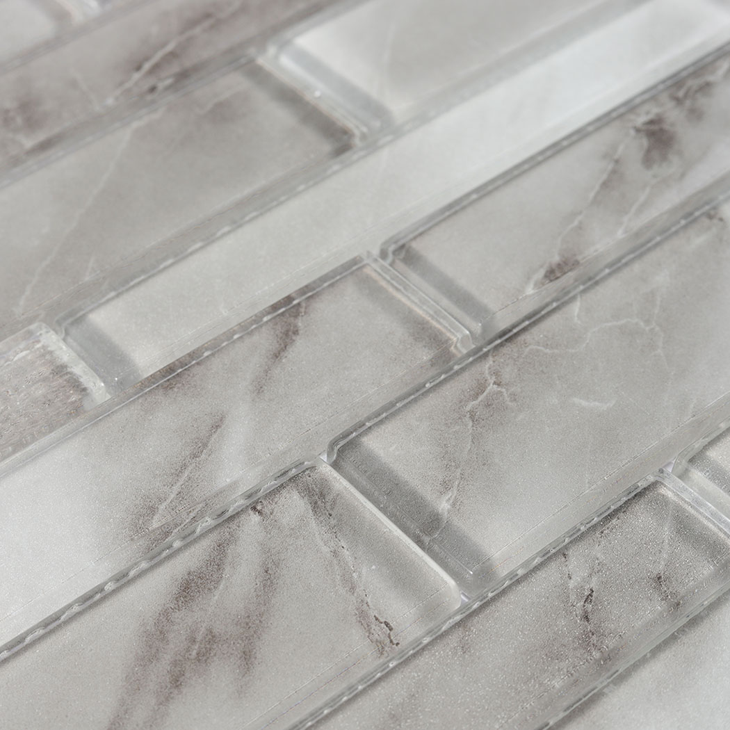 Close pattern of gray veined glass linear mosaic with staggered long strips
