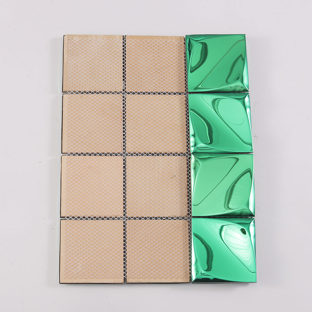 The back of a green 3D metal tile showing the installation mesh and some front facing tiles.