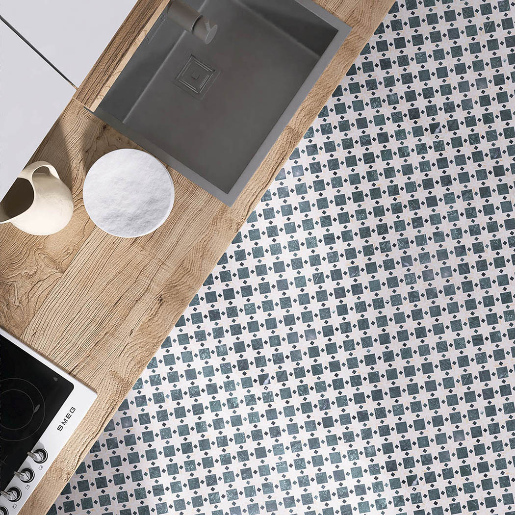 Green and beige marble mosaic tile kitchen floor scene with wood countertop and sink