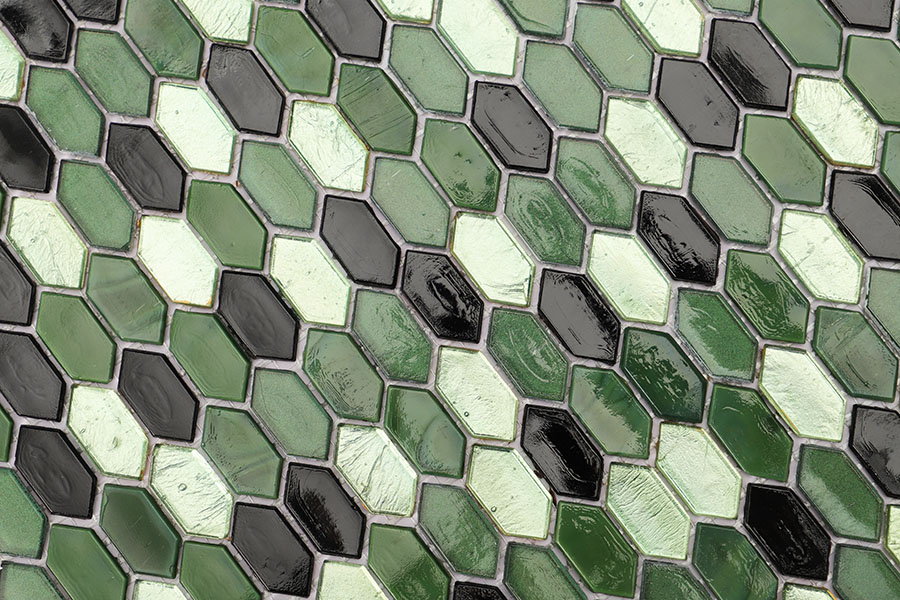 Glass mosaic tiles in a picket shape, featuring dark green, light green, and black colors.