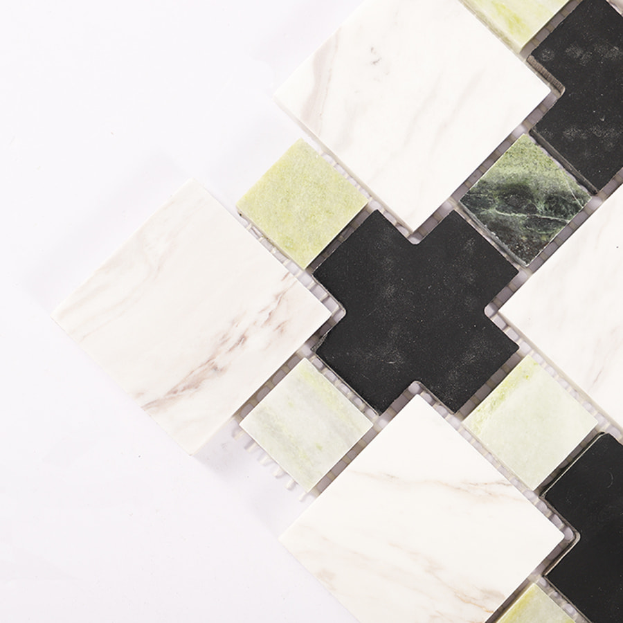 Close up of green black and white geometric marble mosaic tile showing texture.