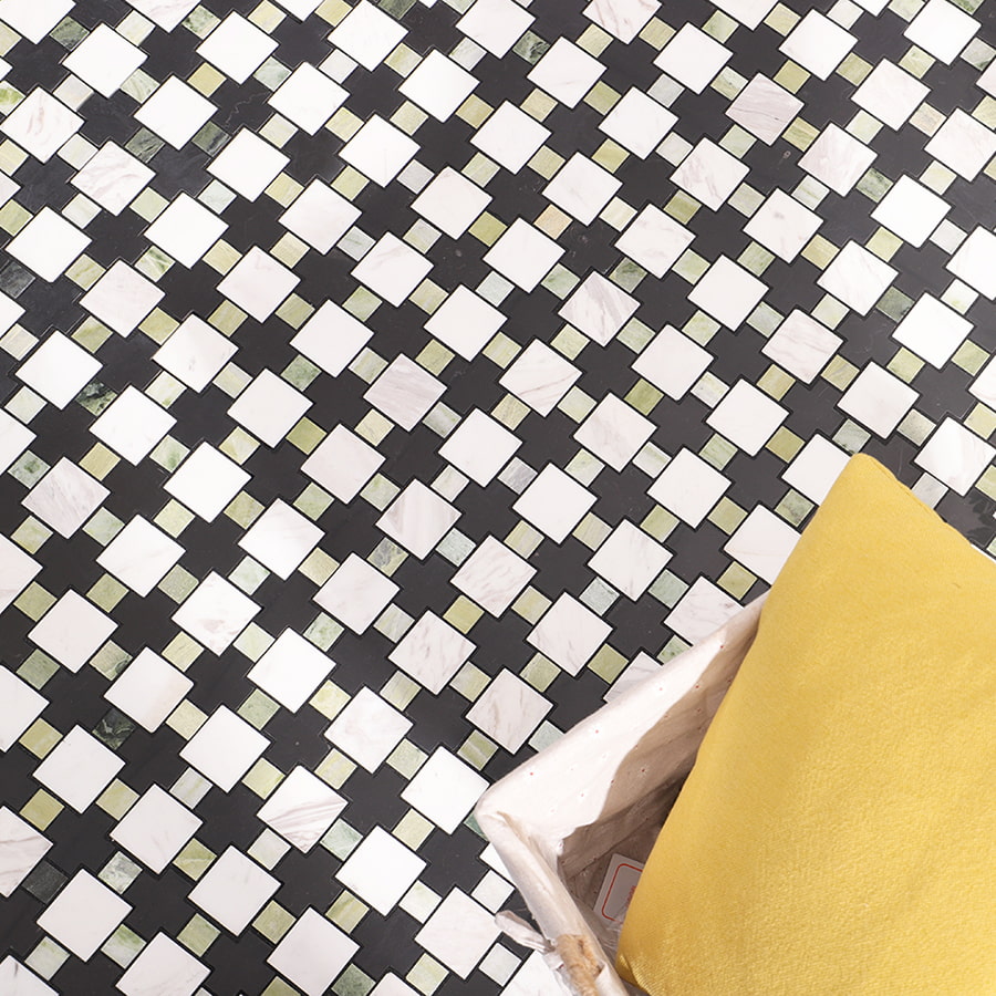 Interior floor decorated with green black and white geometric marble mosaic tile.