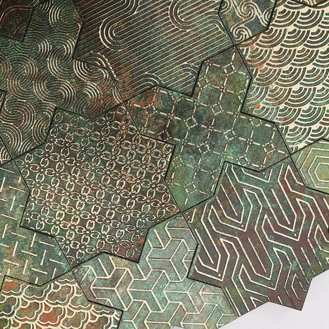 Macro texture showing stamped patterns on green copper finish aluminum tile