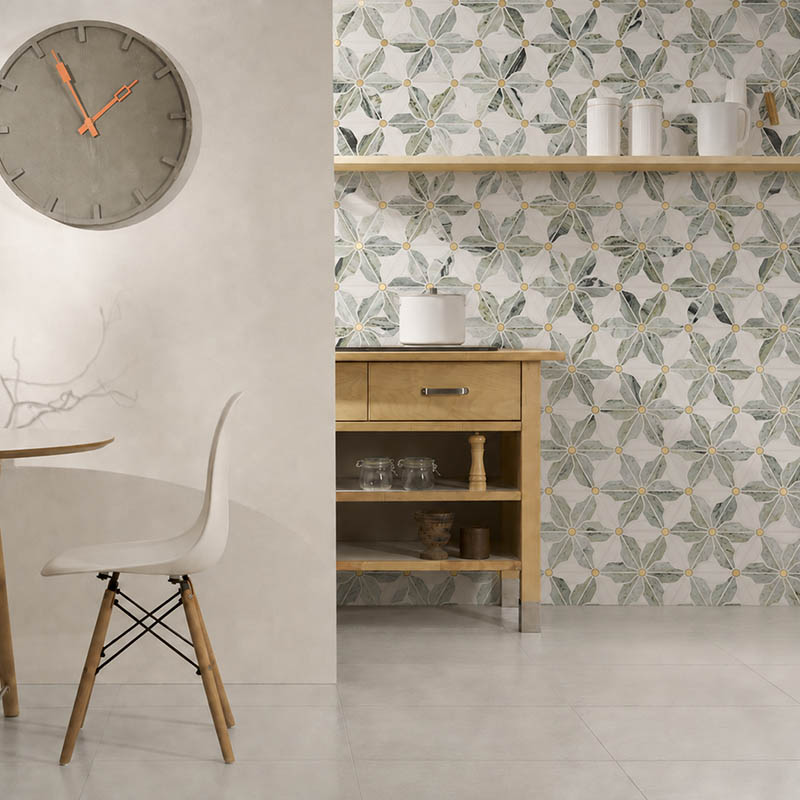 Green flower marble mosaic tiles with gold metal centers on a modern kitchen wall