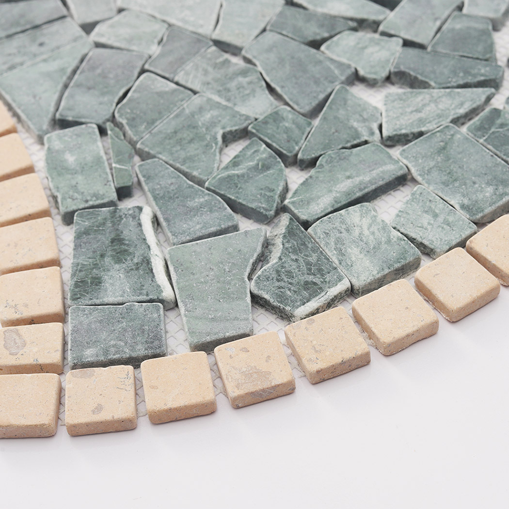 Close up of irregular green marble mosaic pieces with beige border detail