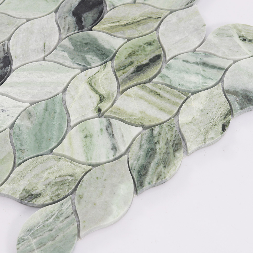Side close up of green leaf marble mosaic tile showing curved shape and thickness