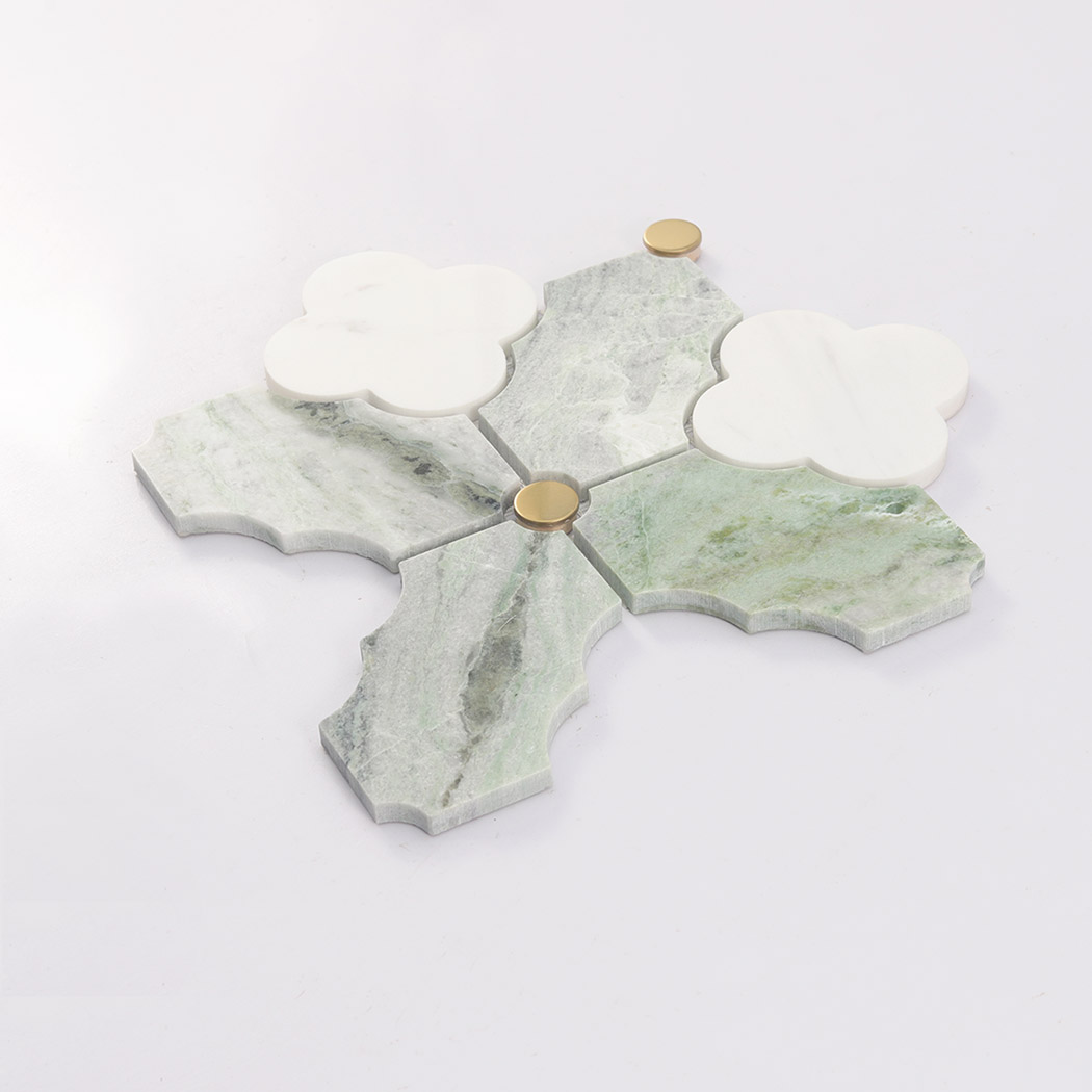 Angled view of green marble arabesque mosaic tile with gold accents