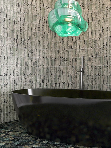 Green marble tiles on the wall and hexagon floor tiles in a modern bathroom