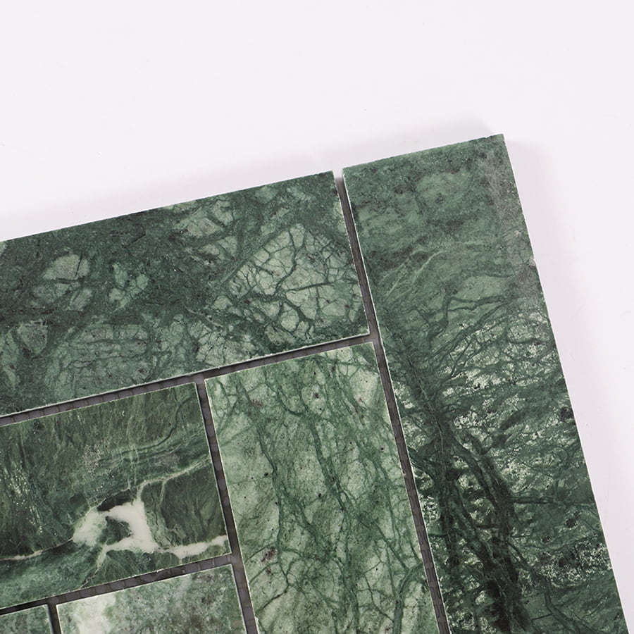 Corner detail close-up of green marble herringbone tile pattern