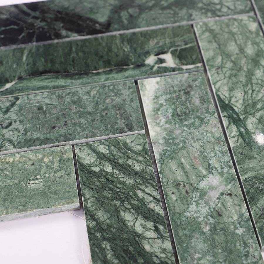 Surface texture detail of green marble herringbone mosaic tile