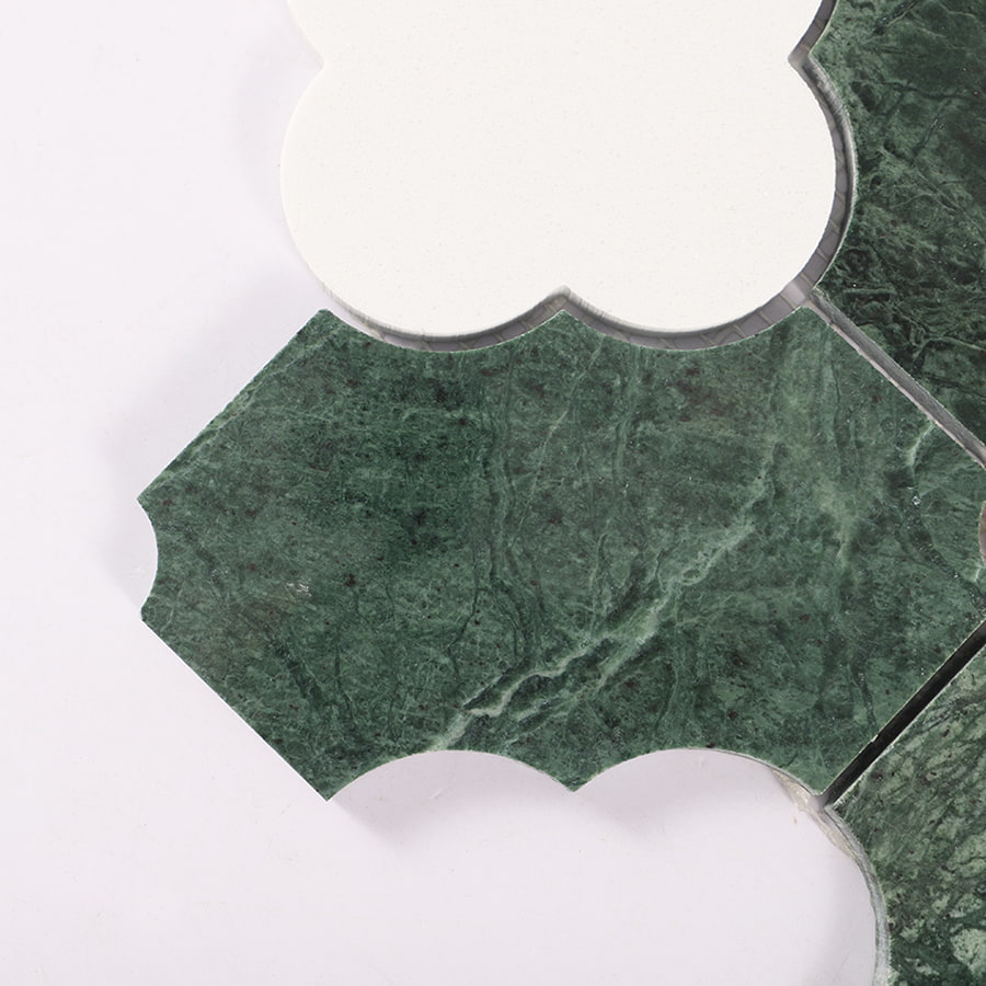 Close up of tile corner showing green marble texture and white clover edge.
